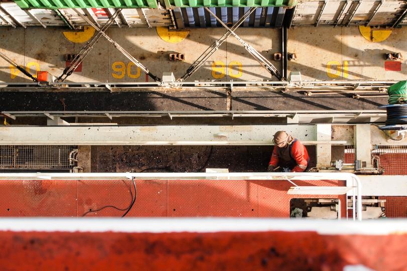 Image of shipping container vessel with worker